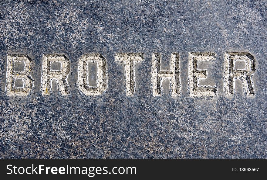 Brother inscription on old grunge granite tombstone.