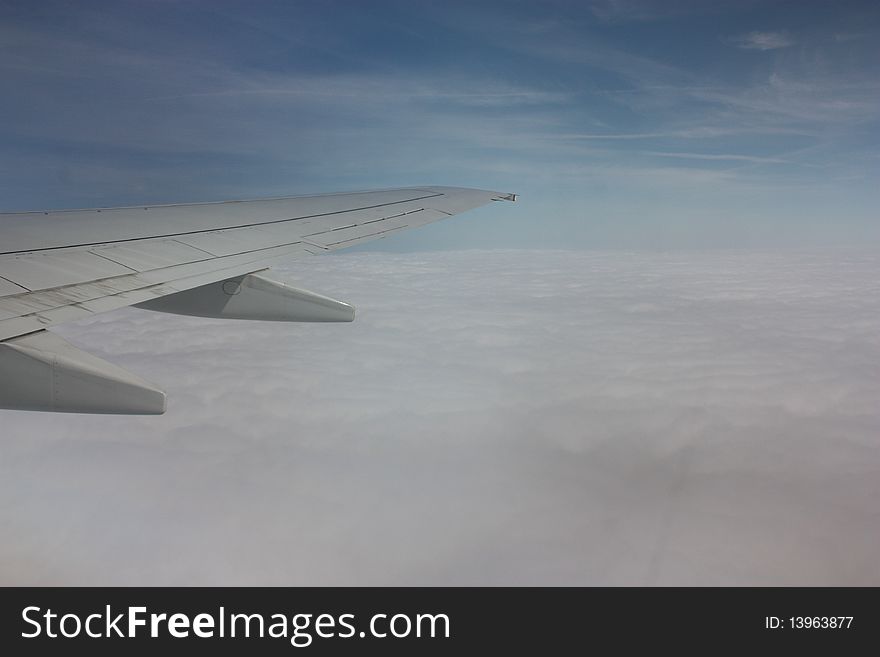 Aircraft wing flying high above the cloud. Aircraft wing flying high above the cloud
