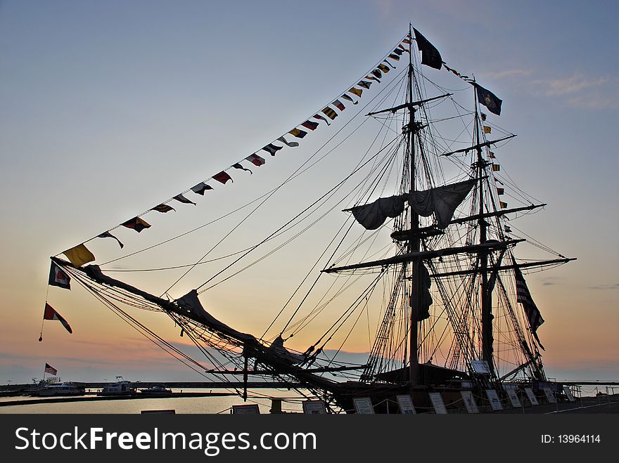 Silhouette of Tall Ship at sunset. Niagara tall ship docked and dressed with flags at sunset, the top flag has on it don't give up the ship. magnificent blue skies and sunset. You can almost feel the hot hazy heat. July 2009. Silhouette of Tall Ship at sunset. Niagara tall ship docked and dressed with flags at sunset, the top flag has on it don't give up the ship. magnificent blue skies and sunset. You can almost feel the hot hazy heat. July 2009