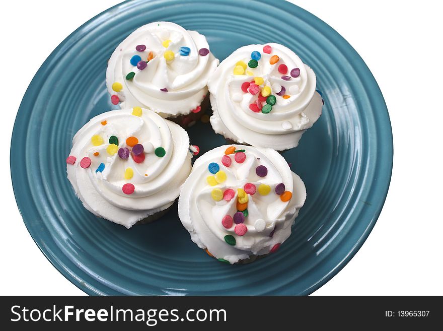 Four cupckes on a turquoise plate isolated on a qhite background. Four cupckes on a turquoise plate isolated on a qhite background