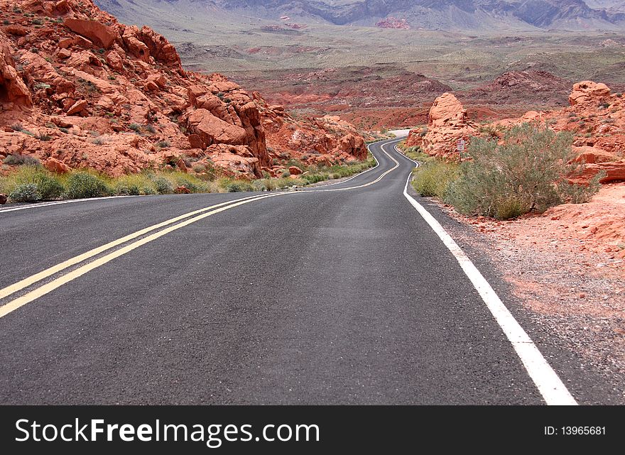 A lonely stretch of highway winding through the desert. A lonely stretch of highway winding through the desert