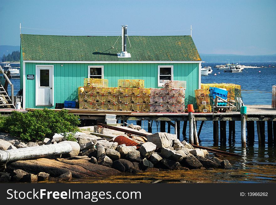 Lobster traps set aside a wooden boat house in Maine. Lobster traps set aside a wooden boat house in Maine