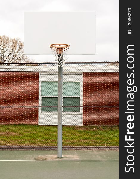An outdoor basketball hoop at a children's school