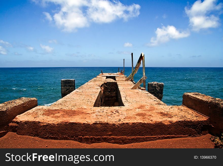 An abandoned concrete pier structure in Hawaii, overlooking the ocean. An abandoned concrete pier structure in Hawaii, overlooking the ocean.