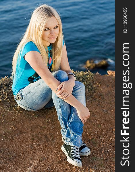 Series. The beautiful blonde on sea background