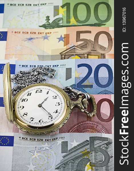 Vintage pocket watch with euro banknotes background. Vintage pocket watch with euro banknotes background