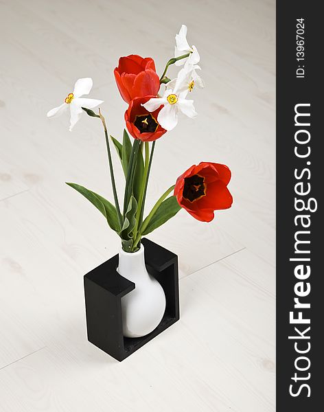 Bouquet of spring flowers in a vase on white laminate flooring ,check also Flowers. Bouquet of spring flowers in a vase on white laminate flooring ,check also Flowers