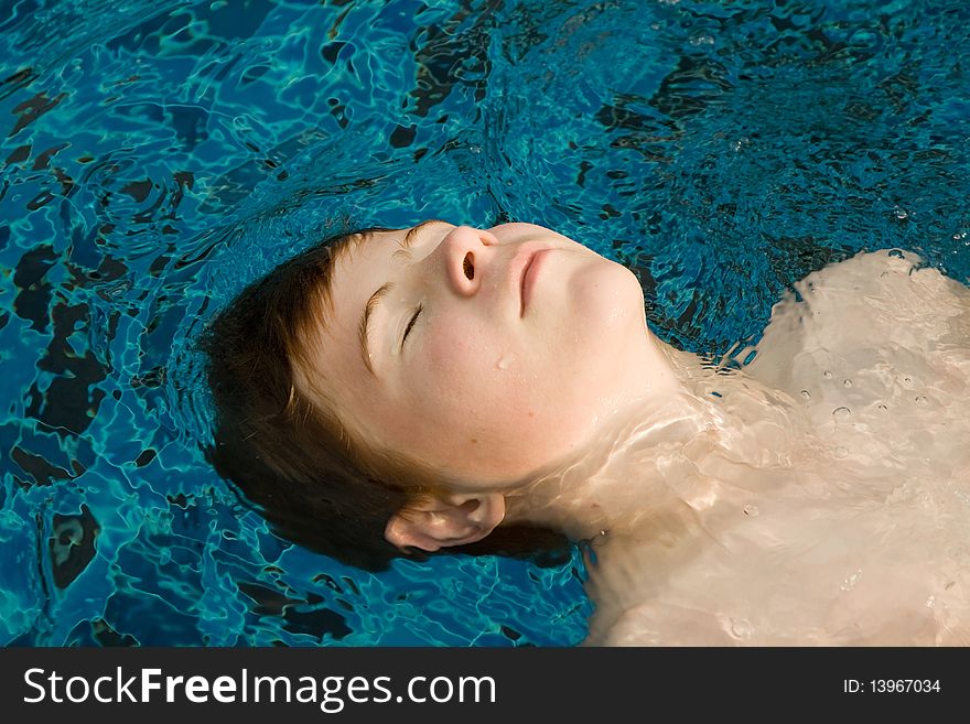 Boy With Red Hair In Pool