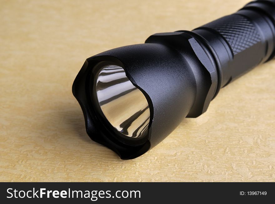 A black metal electric torch, or flashlight, means light, bright, search and finding someting. A black metal electric torch, or flashlight, means light, bright, search and finding someting.
