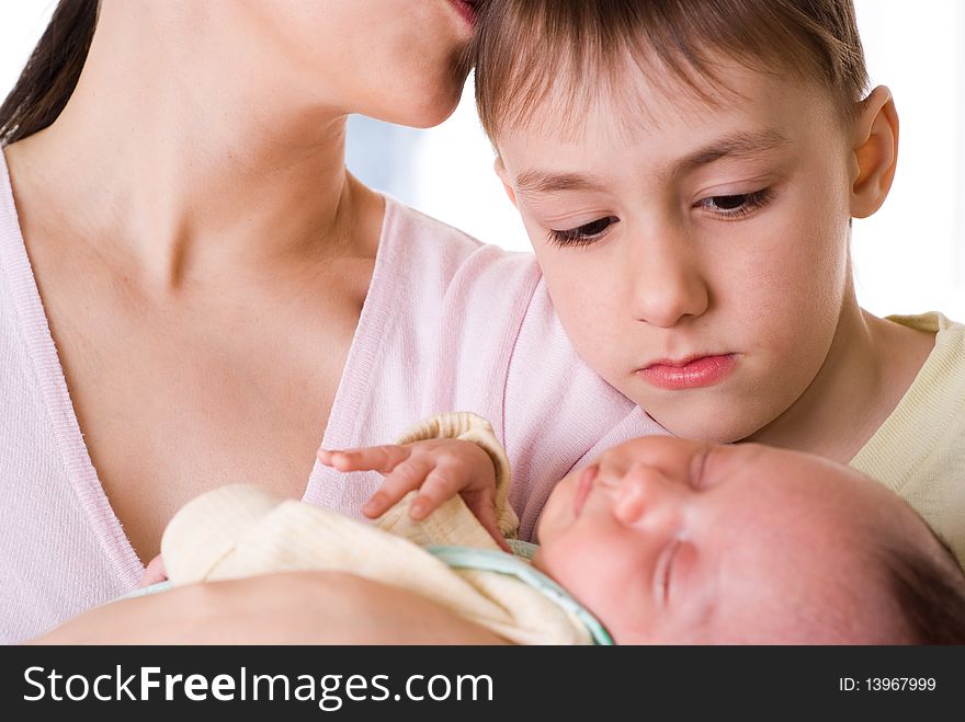 Young mother holds the baby and kissing his son. Young mother holds the baby and kissing his son