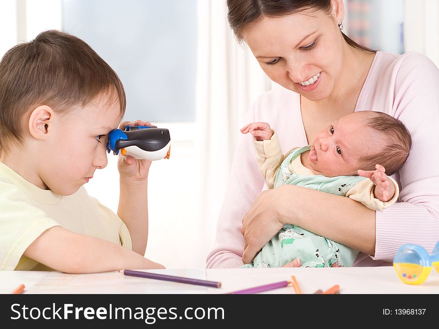 Boy Looking Through Binoculars At The Newborn