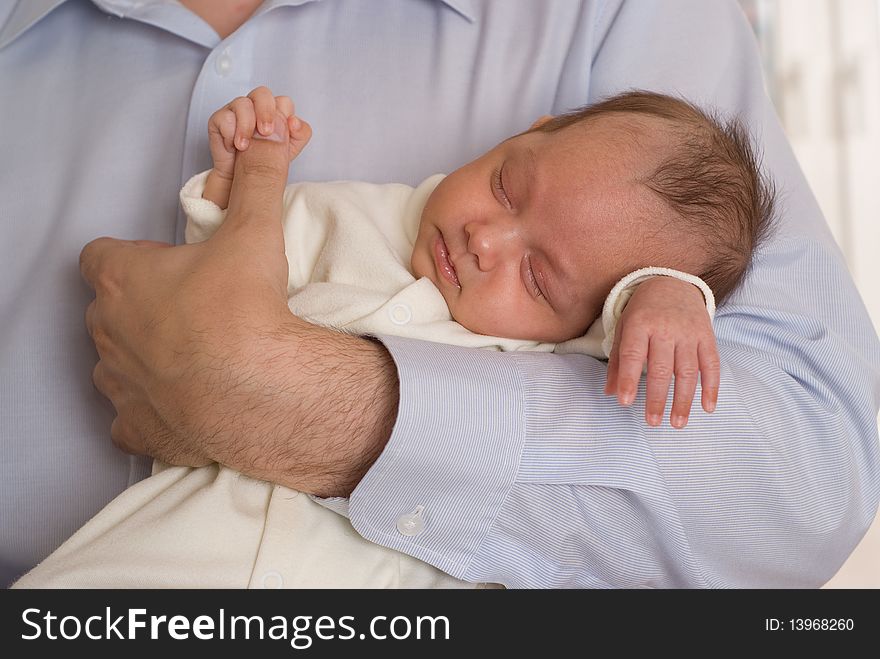 Newborn sleeping peacefully and keeps the finger father. Newborn sleeping peacefully and keeps the finger father