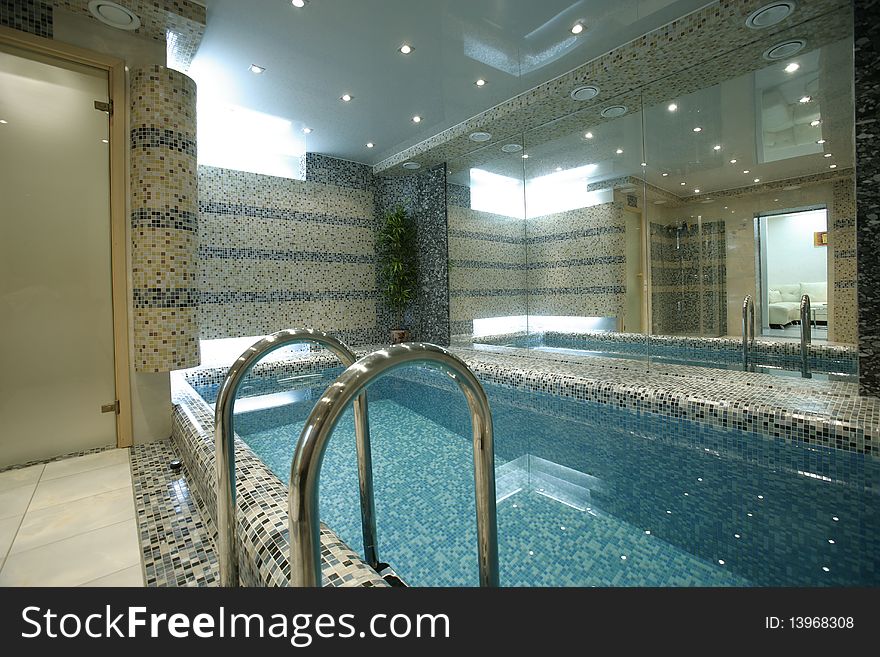 Swimming pool with big mirror in apartment