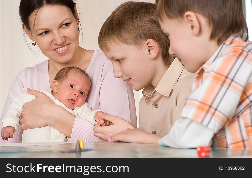 Mother with two sons and newborn at home. Mother with two sons and newborn at home