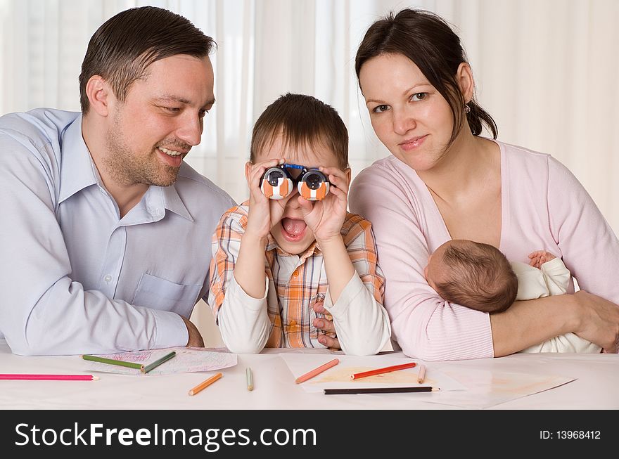 Family of four sitting at the table. Family of four sitting at the table