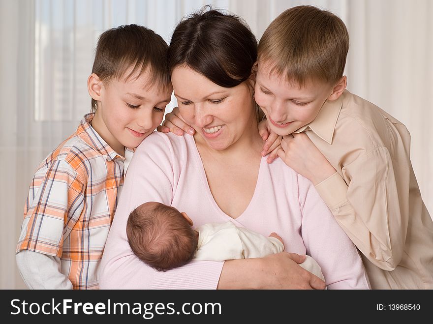 Young mother with three kids resting at home