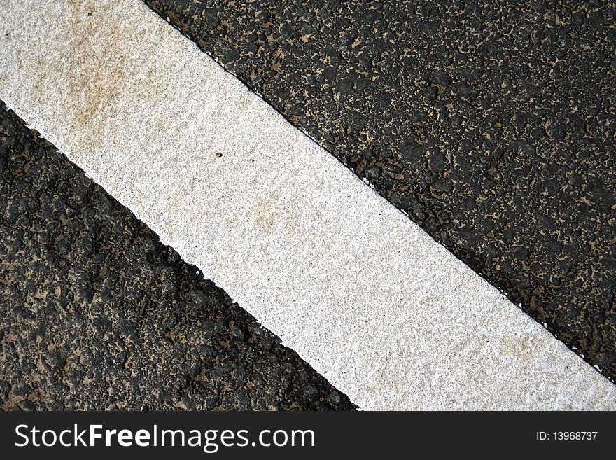 Grungy, dirty view of asphalt with distinct white stripe. Grungy, dirty view of asphalt with distinct white stripe