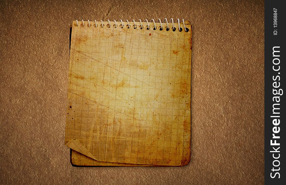 Dirty old notebook in a darkened background. Dirty old notebook in a darkened background