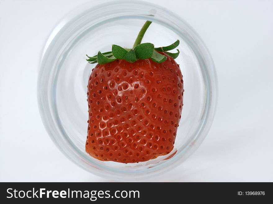 Oddly shaped strawberry inside a wine glass