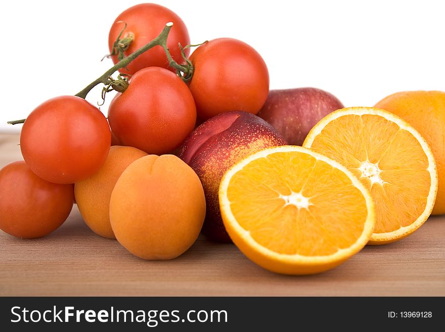 Collection of fruits like orange, tomatoes, peach and plums