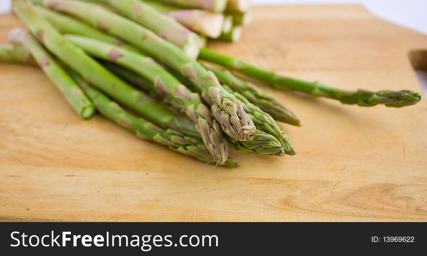 Fresh green asparagus on a wood cutting board. Fresh green asparagus on a wood cutting board.