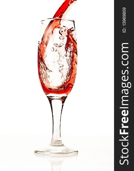 Splashing red wine in glass isolated on white