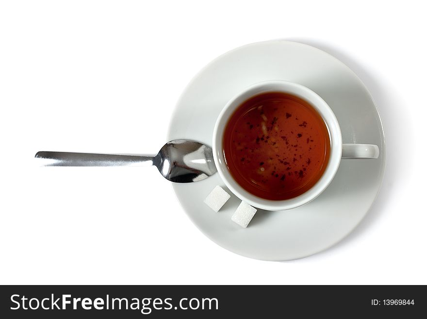 Cup of tea, spoon and sugar isolated over white