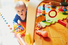 Baby Girl Playing With Toys On The Floor Stock Photos