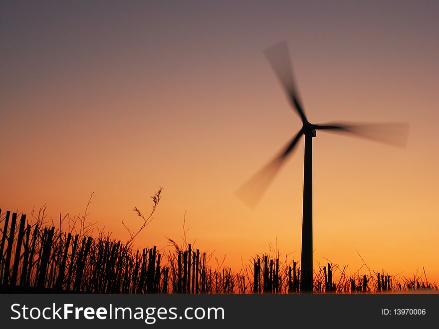 Electric windmill at sunset with beautiful sky.