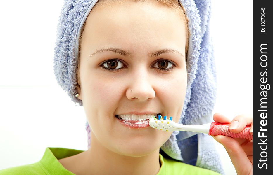 Pretty young girl brushing her teeth. Pretty young girl brushing her teeth