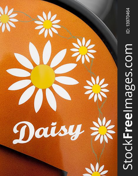 Multiple daisy patterns on an orange glitter vehicle panel