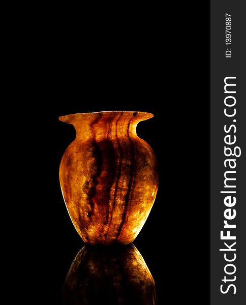 Alabaster vase in dark background with light reflect