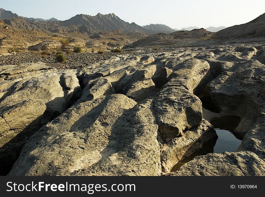 Dry river-bed, faraway mountains. Dry river-bed, faraway mountains
