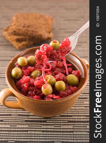 Salad with olive in a pot with black bread. Salad with olive in a pot with black bread