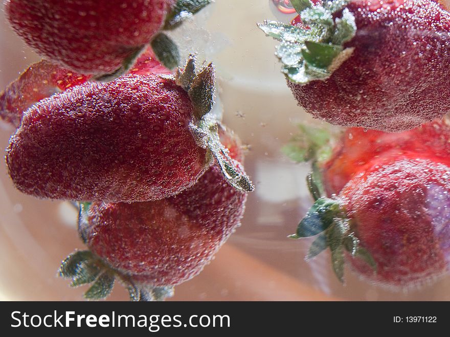 Strawberries in water with color background