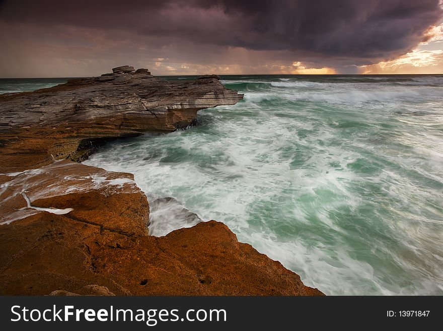 Image of a sunset with rain in the background in  South Africa near Cape Town. Image of a sunset with rain in the background in  South Africa near Cape Town