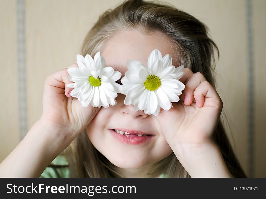 An image of a girl with camomiles on her eyes. An image of a girl with camomiles on her eyes