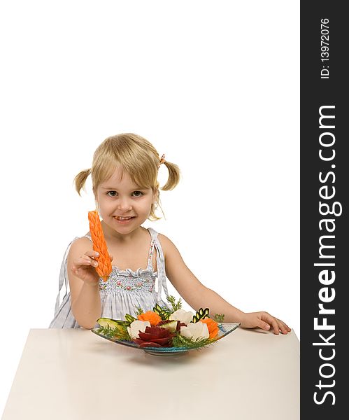 Little girl eating vegetables - chomping a carrot - isolated