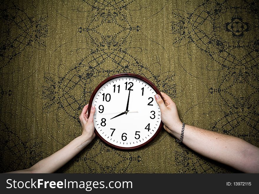 An image of a big white clock on the wall. An image of a big white clock on the wall