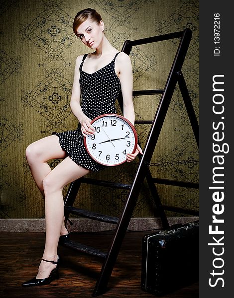 An image of a woman with a big white clock. An image of a woman with a big white clock