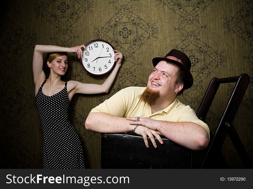 An image of man and woman with a clock. An image of man and woman with a clock