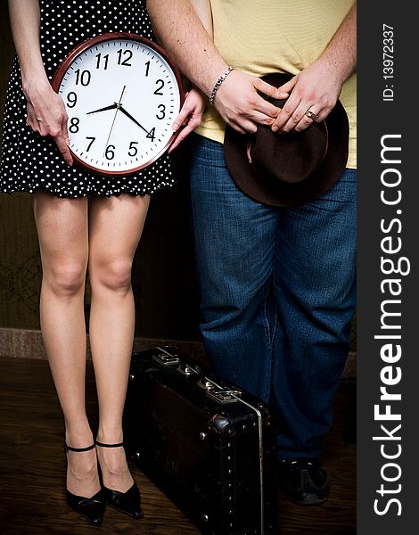 An image of man and woman with hat and clock. An image of man and woman with hat and clock