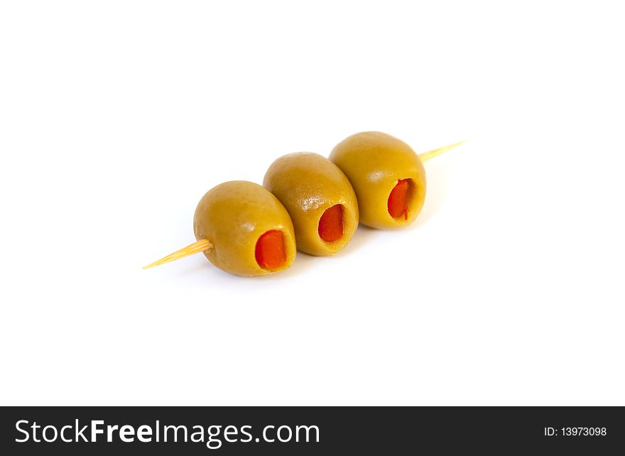 3 olives on a toothpick on a white background. 3 olives on a toothpick on a white background.