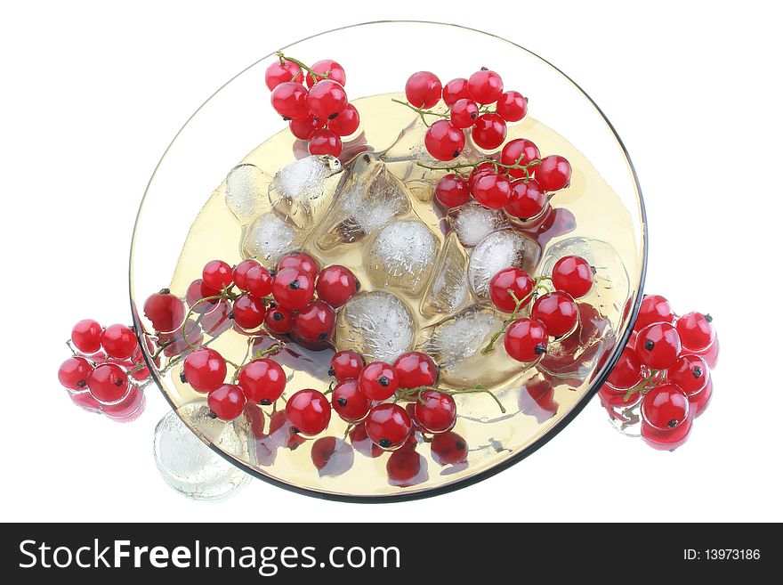 Red currant in the glass plate with an ice. Isolated on white background