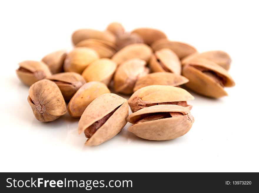 Fried pistachios on a white background