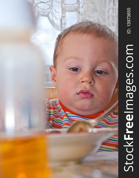 Young baby boy with bottle of juice