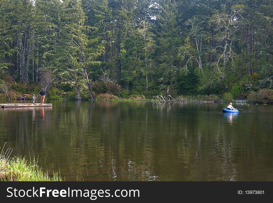 Tranquil scene of people fishing in a lake