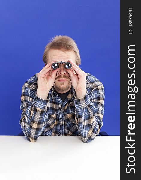 Man watches with his binoculars. Man watches with his binoculars.