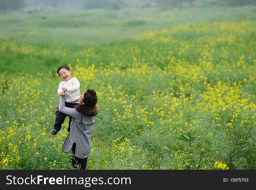 Mother and son play in flowers