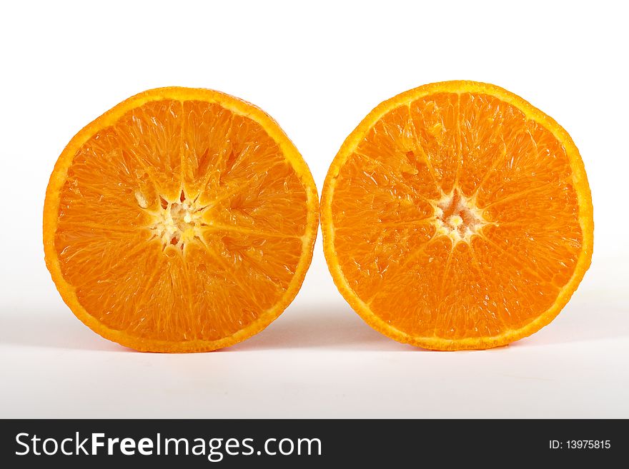 Juicy half orange, fresh fruit against a white background
